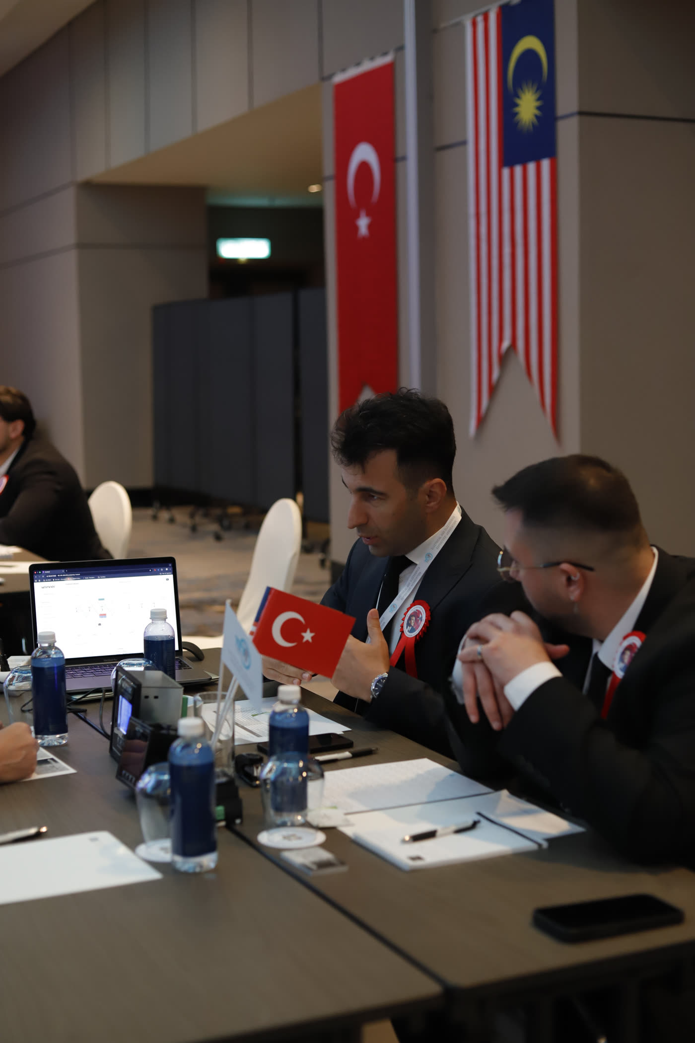 Mertcan Çakır holding the Turkish flag during the Kuala Lumpur trade delegation